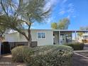 Charming single-story home with a covered entrance, mature landscaping, and plenty of greenery at 124 S 54Th St # 42, Mesa, AZ 85206