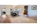 Elegant dining room with chandelier lighting, wood floors, and traditional furnishings at 14532 N 146Th Ln, Surprise, AZ 85379
