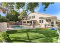 Expansive backyard with a fenced pool, outdoor bar, pergola, and artificial turf at 1901 W Mulberry Dr, Chandler, AZ 85286