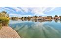 A view of a serene community pond reflecting the blue sky and clouds on a sunny day at 1901 W Mulberry Dr, Chandler, AZ 85286