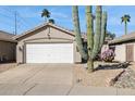 Home exterior featuring desert landscaping and a cactus in the front yard at 20218 N 33Rd Pl, Phoenix, AZ 85050