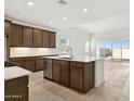 Bright kitchen featuring stainless steel appliances, a large island, modern cabinets and tile floors at 25606 N 154Th Ln, Surprise, AZ 85387