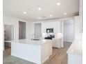Open kitchen with island features modern appliances, recessed lights, and easy access to dining at 25606 N 154Th Ln, Surprise, AZ 85387