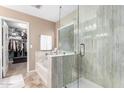 Bright bathroom featuring a bathtub, shower, tile, and walk-in closet at 32795 N Hidden Canyon Dr, San Tan Valley, AZ 85144