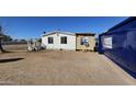 Side exterior view of a single-story home showing peeling paint and sparse landscaping at 508 S 98Th St, Mesa, AZ 85208