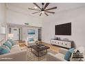Spacious living room with high ceilings, large TV, and comfortable seating, creating an inviting atmosphere at 8201 W Tuckey Ln, Glendale, AZ 85303
