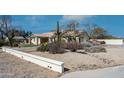 Desert-style home exterior featuring native landscaping with cacti and gravel at 8310 W Daley Ln, Peoria, AZ 85383