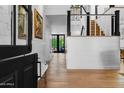 Welcoming hallway features hardwood floors, shiplap walls, and staircase, filled with natural light at 8607 N Farview Dr, Scottsdale, AZ 85258
