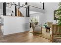 Bright living room with shiplap walls, staircase, hardwood floors, and comfortable seating arrangement at 8607 N Farview Dr, Scottsdale, AZ 85258