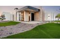 Stunning modern home with a unique exterior, lush landscaping, and inviting entrance at 10220 N 66Th St, Paradise Valley, AZ 85253