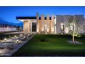 Chic modern home with elegant lighting, lush lawn, and a striking architectural design at 10220 N 66Th St, Paradise Valley, AZ 85253