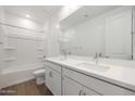 Bright bathroom featuring a double vanity, large mirror, and tile flooring at 1292 S 185Th Dr, Goodyear, AZ 85338