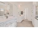 Bright bathroom features a double vanity, modern fixtures, and beautiful tile work in the shower at 13138 N 173Rd Ln, Surprise, AZ 85388