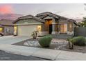 Charming home featuring a two-car garage and beautiful desert landscaping at 16336 N 168Th Ave, Surprise, AZ 85388