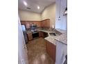 This is a kitchen featuring granite countertops, stainless steel appliances, and ample cabinet space at 16336 N 168Th Ave, Surprise, AZ 85388