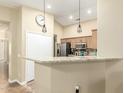 Bright kitchen featuring granite countertops, stainless steel appliances, pendant lighting and tiled flooring at 16336 N 168Th Ave, Surprise, AZ 85388