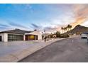 Modern home with desert landscaping, sleek garage door and stylish exterior lighting at 1955 E Greenway Rd, Phoenix, AZ 85022