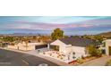 Modern home featuring xeriscaping, a black garage door, and mountain views at 1955 E Greenway Rd, Phoenix, AZ 85022