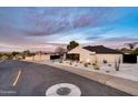 Home exterior with desert landscaping and a modern architectural design at sunset at 1955 E Greenway Rd, Phoenix, AZ 85022