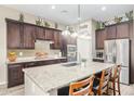 Modern kitchen with granite countertops, stainless steel appliances, and center island with bar seating at 20552 E Reins Rd, Queen Creek, AZ 85142
