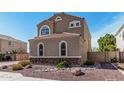 Inviting two-story home with a tile roof, arched windows, and low-maintenance landscaping at 21216 N 96Th Ave, Peoria, AZ 85382
