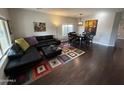 Open living space with modern furnishings, seamlessly combining the living and dining areas at 22803 S 215 St, Queen Creek, AZ 85142