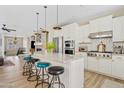 Spacious kitchen with white cabinets, a marble island, stainless steel appliances, and a gas stove at 2643 E Tamarisk St, Gilbert, AZ 85296