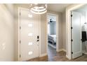 Bright entryway featuring wood-look floors, a modern front door, and a view into the bedroom at 2819 N 28Th Pl, Phoenix, AZ 85008