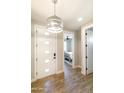 Entryway featuring wood-look floors, a modern front door, and a view into the bedroom at 2819 N 28Th Pl, Phoenix, AZ 85008