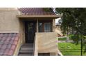 Inviting condo entrance featuring stairs, a tiled roof, and mature tree at 4901 S Calle Los Cerros Dr # 206, Tempe, AZ 85282