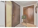 Well-lit foyer with a large front door with decorative window and closet with wooden doors at 6240 N 16Th St # 37, Phoenix, AZ 85016