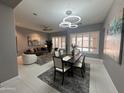 Open-concept living and dining area with stylish furnishings and contemporary light fixtures at 7865 S Palm Dr, Tempe, AZ 85284