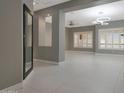 Spacious living room featuring neutral tones, recessed lighting, and modern window shutters at 7865 S Palm Dr, Tempe, AZ 85284