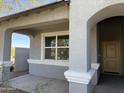 Cozy front porch with decorative columns and stucco walls at 1075 W Avalon Canyon Dr, Casa Grande, AZ 85122