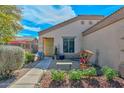 Lovely single story home with tidy landscaping featuring rocks, shrubs, and decorative garden features at 12721 W Valentine Ave, El Mirage, AZ 85335