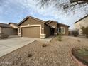 Charming home with a well-maintained yard, desert landscaping, and a spacious driveway at 1298 S 222Nd Ln, Buckeye, AZ 85326