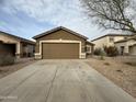 Exterior shot showcasing the home's curb appeal, driveway, and desert landscaping at 1298 S 222Nd Ln, Buckeye, AZ 85326