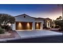 Beautiful home showcasing a three-car garage and stone accents, complemented by desert landscaping at 13117 W Micheltorena Dr, Sun City West, AZ 85375