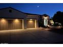 Inviting home exterior at dusk features a multi-car garage and professionally landscaped yard at 13117 W Micheltorena Dr, Sun City West, AZ 85375