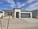 Charming single-story home with a gray roof, neutral stucco exterior, and a two-car garage at 15406 W Hackamore Dr, Surprise, AZ 85387