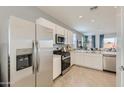 This open concept kitchen has stainless steel appliances and flows seamlessly into the living area at 15579 W Williams St, Goodyear, AZ 85338