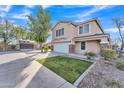 Charming two-story home boasting well-kept landscaping, a spacious driveway, and a cozy, covered front porch at 16029 N 171St Dr, Surprise, AZ 85388