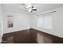 Bright bedroom with hardwood floors, a ceiling fan, and natural light from two windows at 1920 E Bell Rd # 1153, Phoenix, AZ 85022