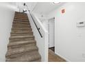 Carpeted staircase with white walls and a handrail leading to the upper level of the home at 1920 E Bell Rd # 1153, Phoenix, AZ 85022