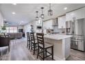 Stylish kitchen with stainless steel appliances, a large island with seating, and modern pendant lighting at 2008 E Mitchell Dr, Phoenix, AZ 85016