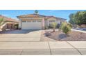 Front exterior of a single-story home showcasing desert landscaping and a two-car garage at 2091 E Flintlock Way, Chandler, AZ 85286