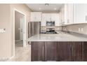 Modern kitchen featuring stainless steel appliances, white cabinets and stone countertops at 2101 S Yellow Wood -- # 22, Mesa, AZ 85209