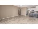 Open-concept living room with neutral paint, tiled floor and kitchen view at 2101 S Yellow Wood -- # 22, Mesa, AZ 85209