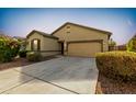 Charming single-story home with manicured landscaping and a spacious driveway at 2379 E San Miguel Dr, Casa Grande, AZ 85194