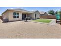 Spacious backyard with gravel, a small grass patch, and a patio area perfect for outdoor entertaining at 26020 N 138Th Ln, Peoria, AZ 85383